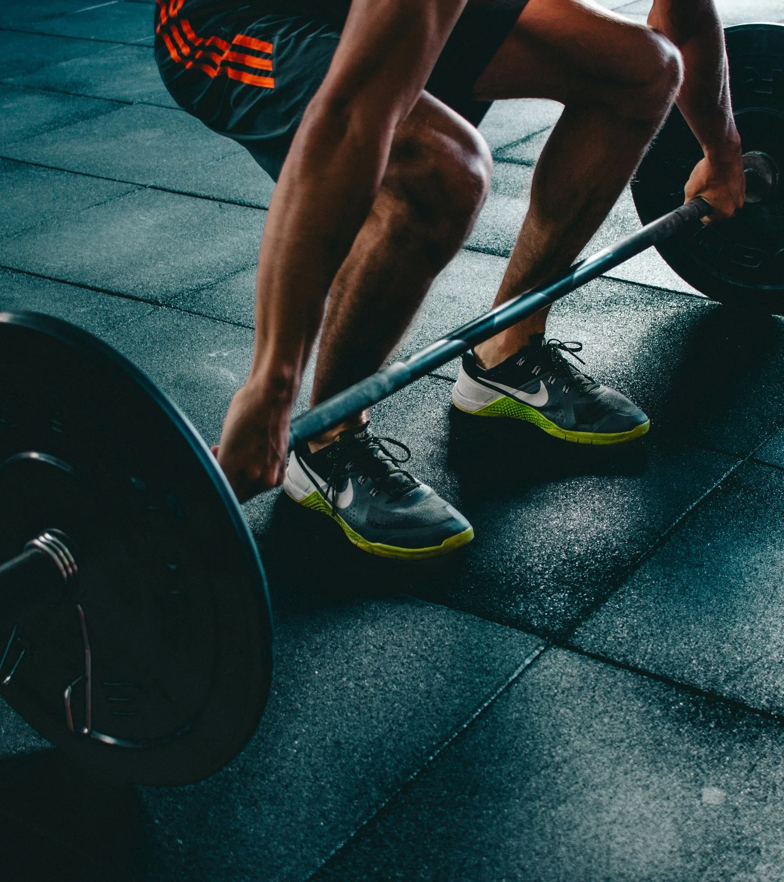 An athlete setting up over a loaded barbell.